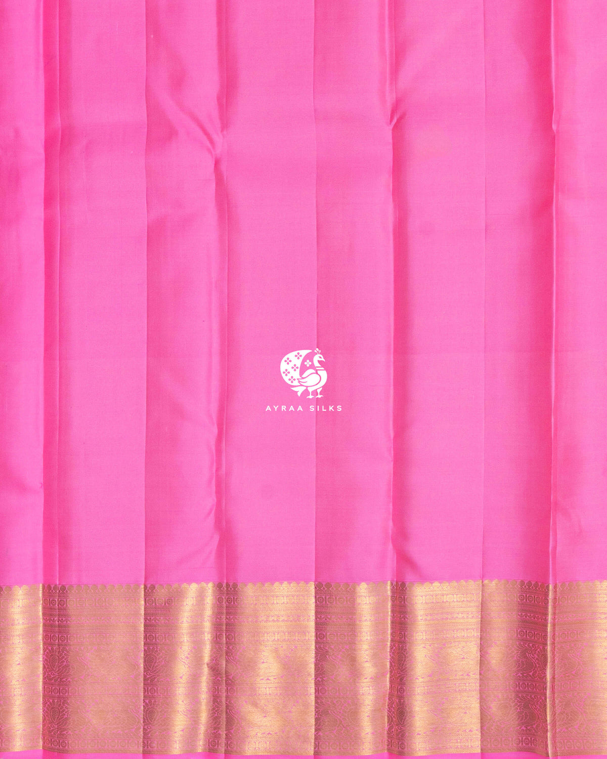 Close view of the running blouse in plain bright pink silk with a gold zari border