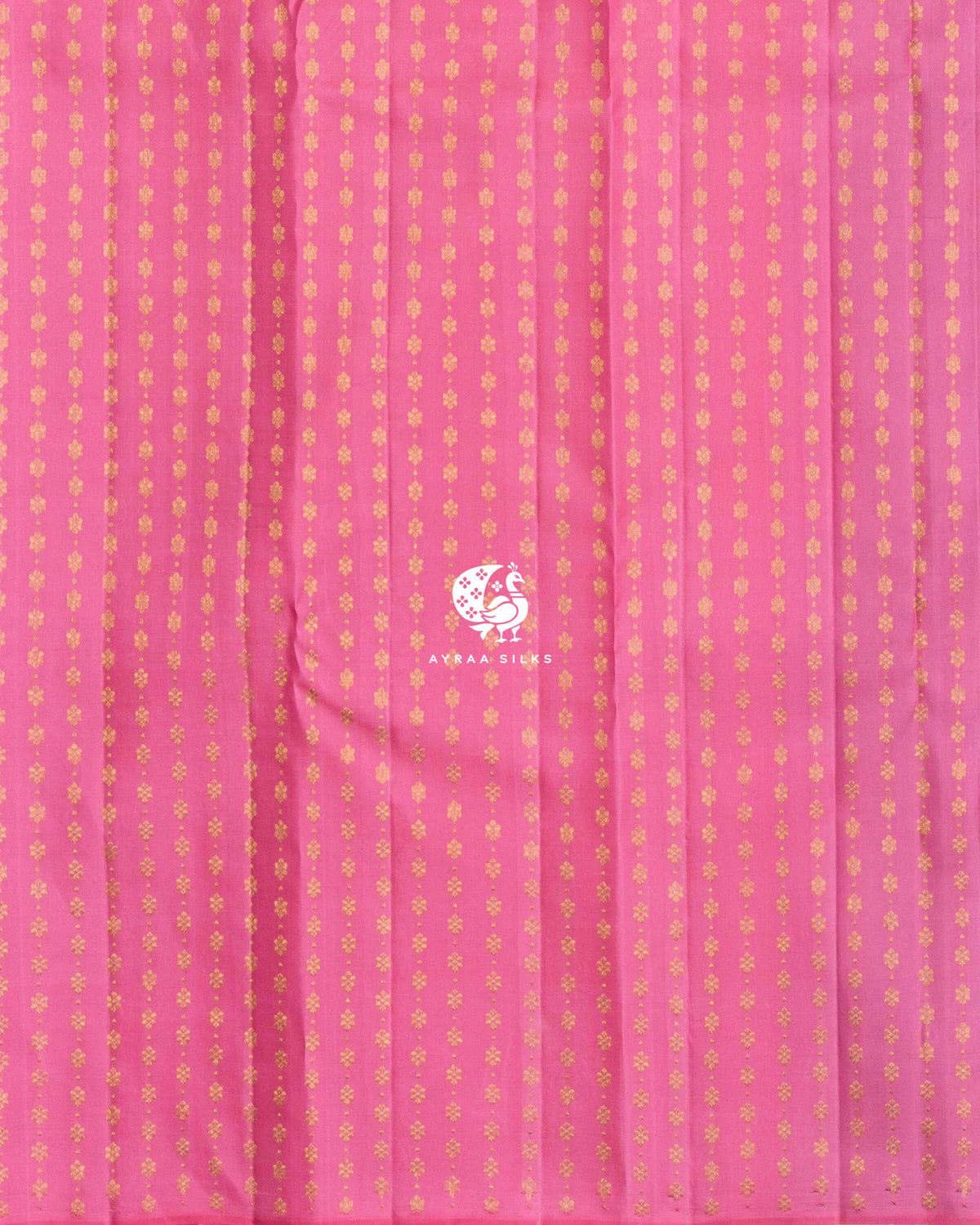 Close view of the running blouse in pink pure Kanchipuram silk with rows of floral zari buttas