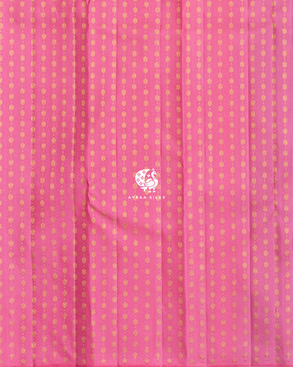 Close view of the running blouse in pink pure Kanchipuram silk with rows of floral zari buttas