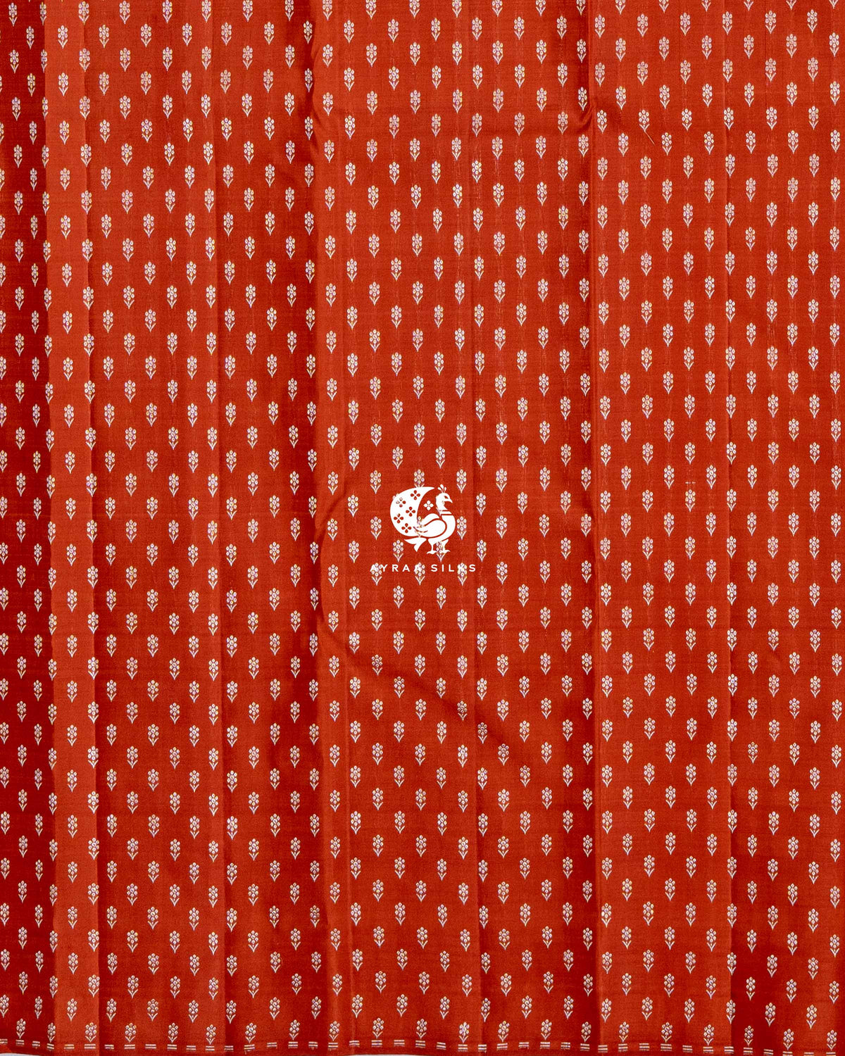 Close view of the running blouse in rust orange pure Kanchipuram silk with rows of floral zari buttas
