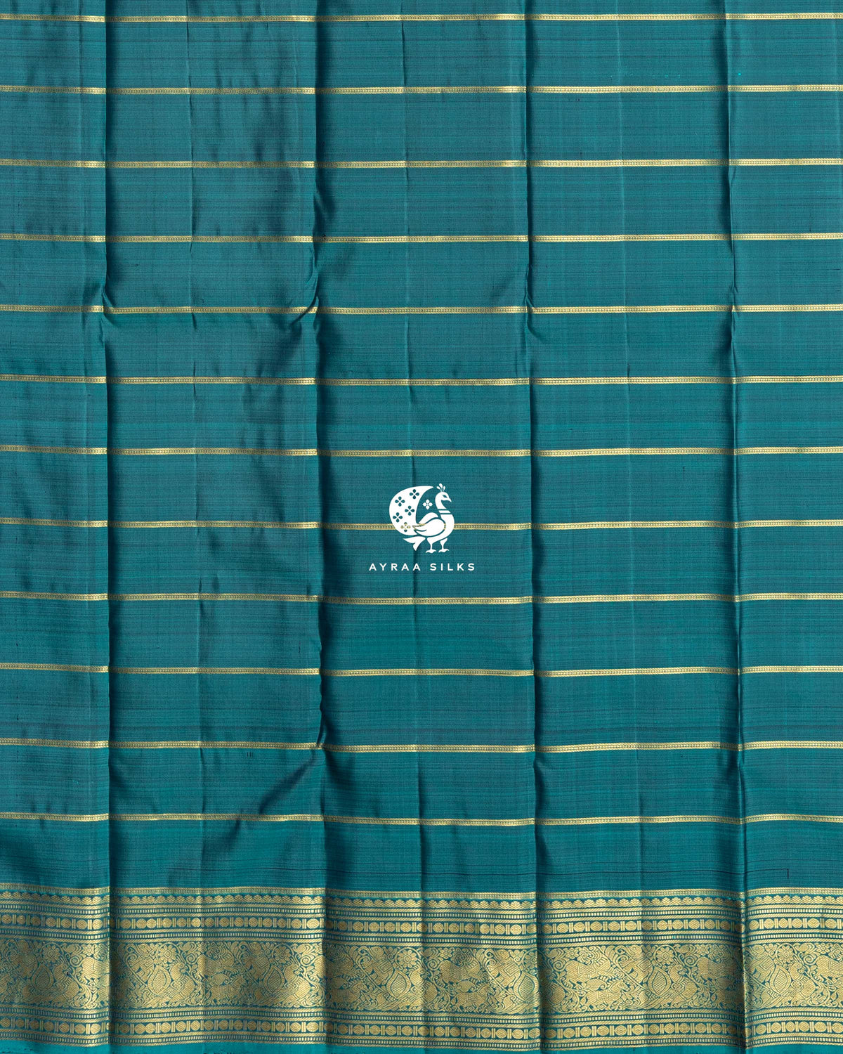 Close view of the running blouse in teal silk with gold zari stripes and a zari border