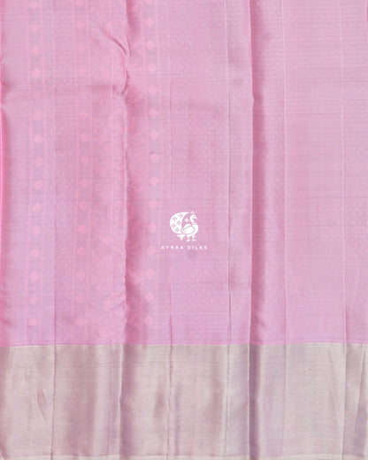 Close view of the running blouse in pastel pink silk with a zari border