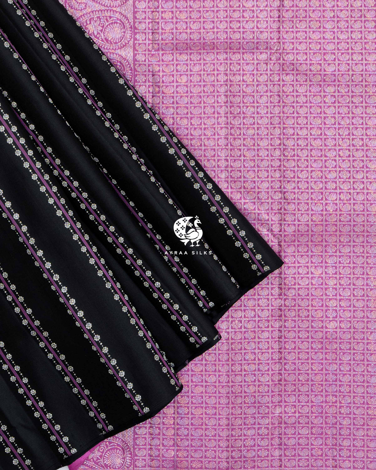 Pleats of Black Floral Vari Kanchipuram silk saree laid over its orchid pink zari pallu