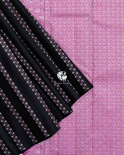 Pleats of Black Floral Vari Kanchipuram silk saree laid over its orchid pink zari pallu