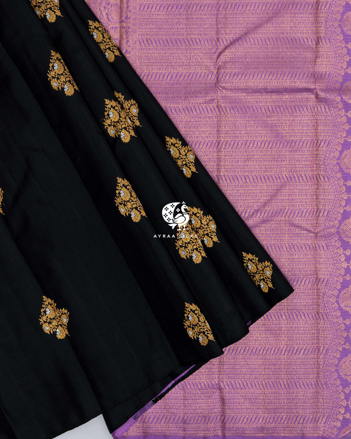 Black pleats with gold zari floral buttas laid over the lavender zari pallu