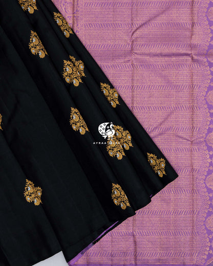 Black pleats with gold zari floral buttas laid over the lavender zari pallu