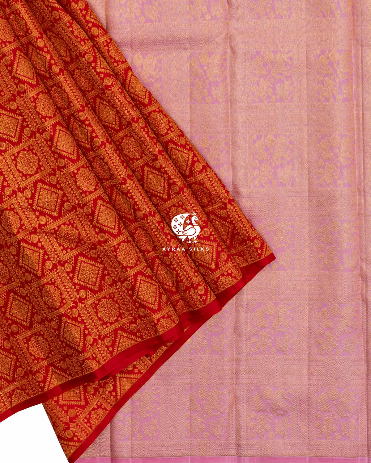 Red zari brocade pleats laid over the baby pink zari pallu with Mayil (peacock) and floral panels