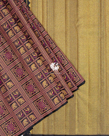 Black brocade pleats with elephant and peacock checks laid over the gold zari chevron pallu