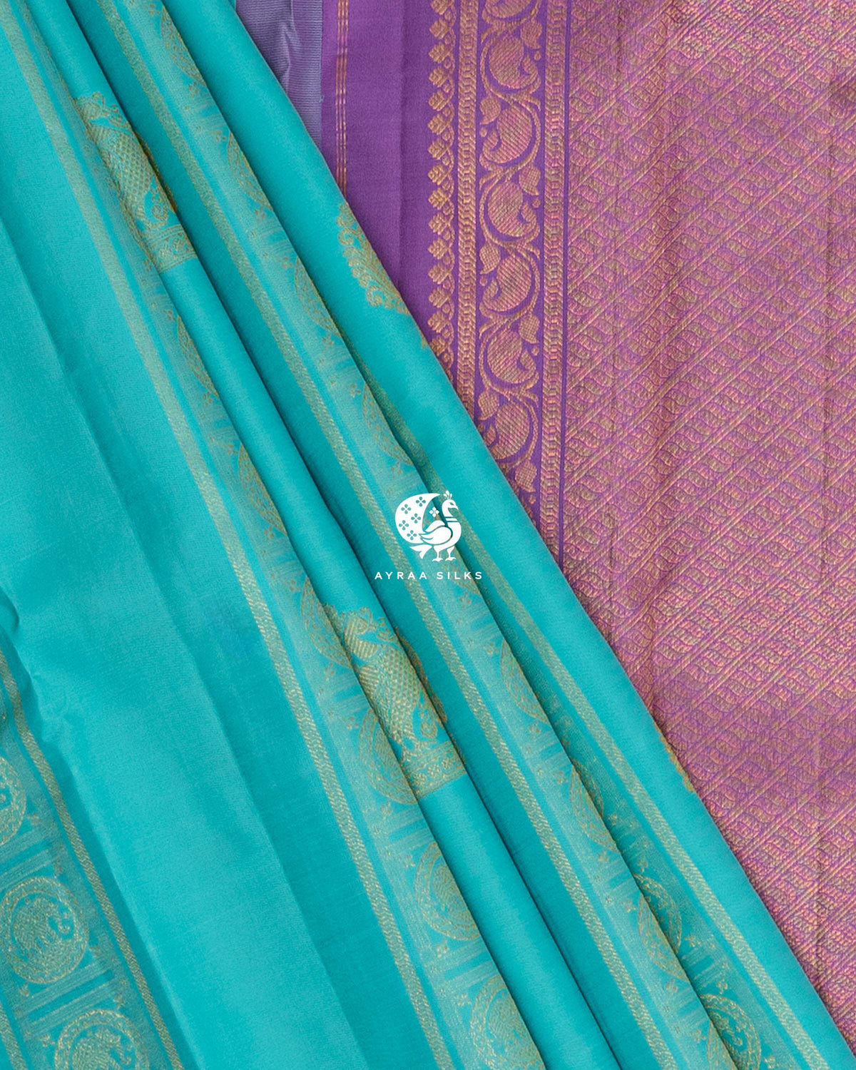 Turquoise Kanchipuram silk saree pleats beside the lavender zari pallu with manga (paisley) scroll border