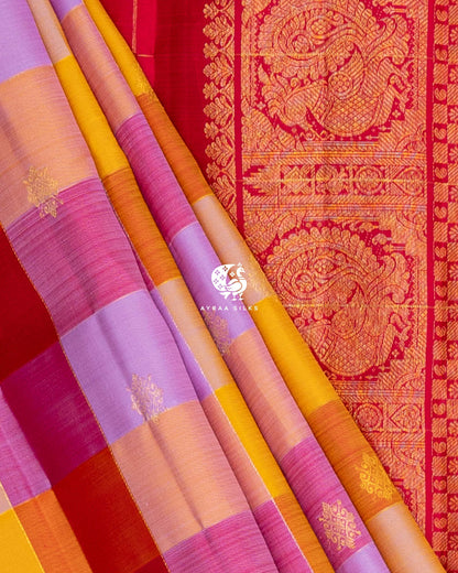 Close view of multicolour checked pleats beside the Mayil Chakra (peacock medallion) zari border of the red pallu