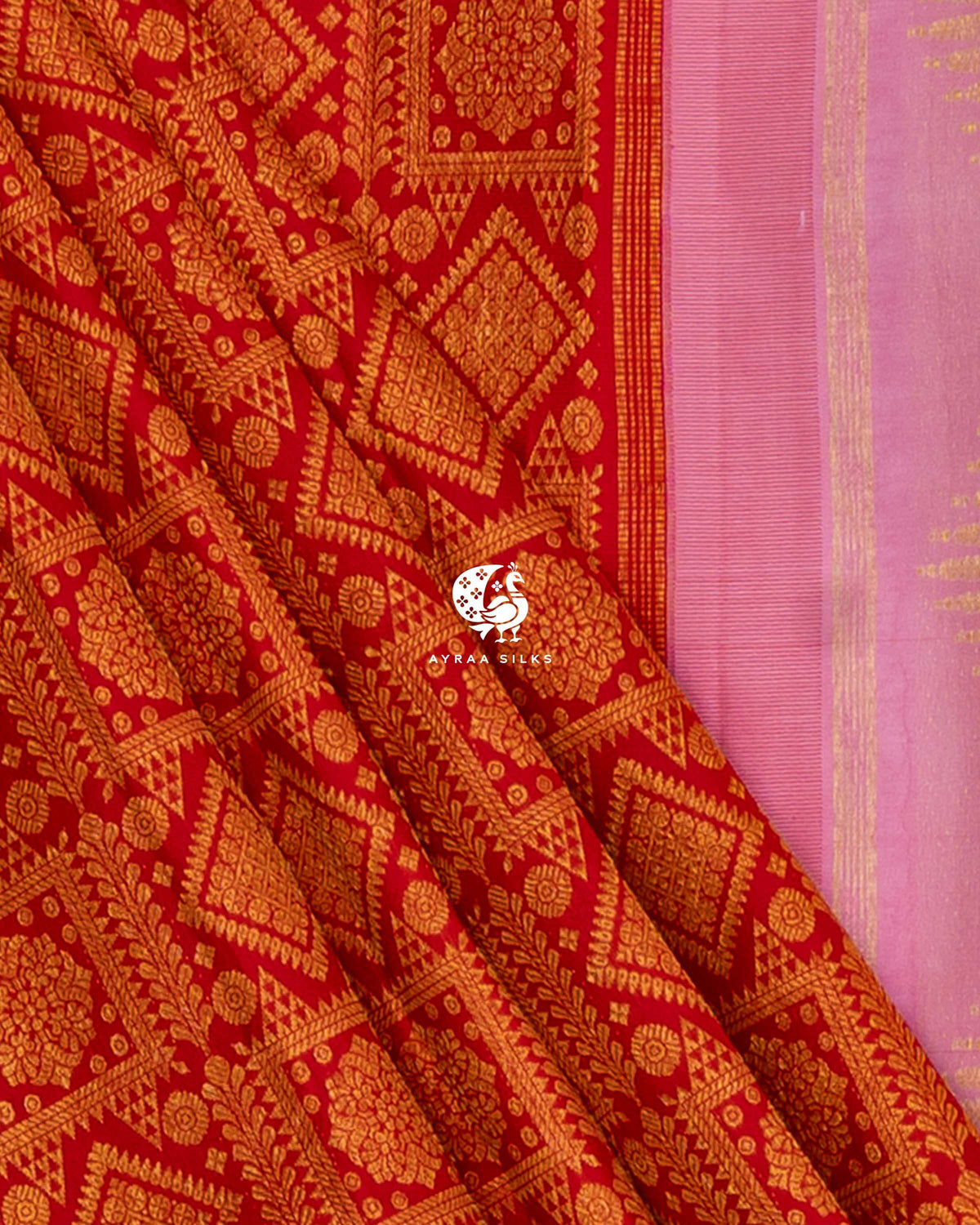 Close view of red zari brocade pleats beside the baby pink pallu edge with temple motifs in zari