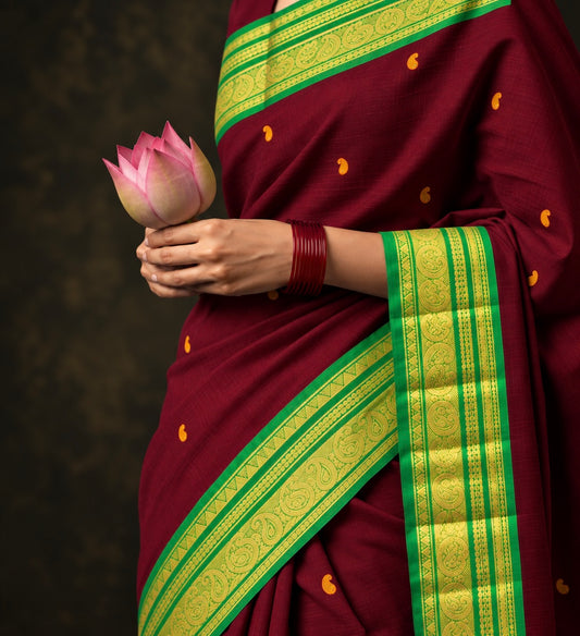 Maroon butta Kanchi cotton saree draped, green zari mankolam border and mustard buttas — handwoven pure cotton by Ayraa Silks