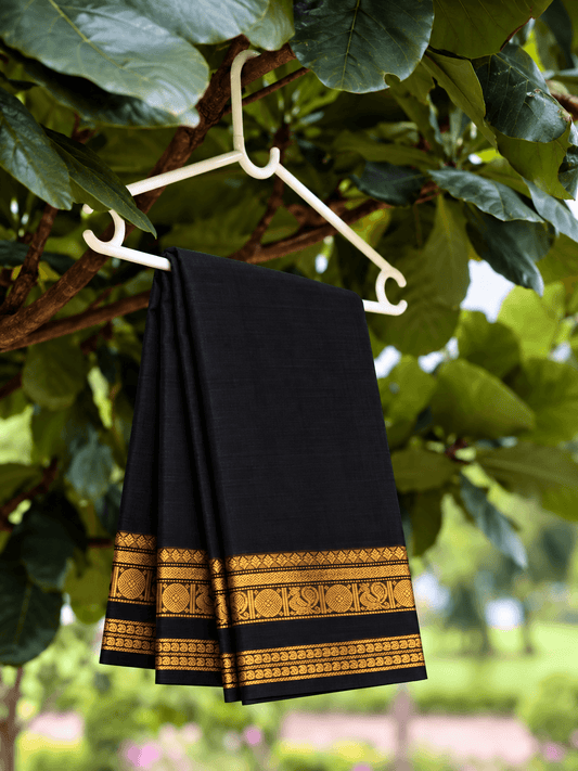 Black mayil Kanchi cotton saree on a hanger, gold zari peacock border — handwoven pure cotton by Ayraa Silks